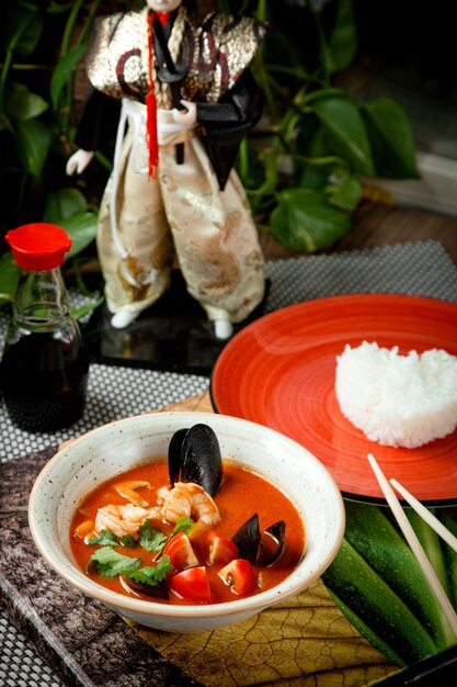 mussel soup with tomatoes in bowl