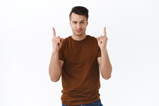 Must have right here click this link Portrait of sassy goodlooking macho man pointing fingers up and smiling pleased give direction showing way to cool promo standing white background