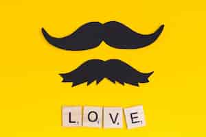 Free photo mustache with text love on bright background