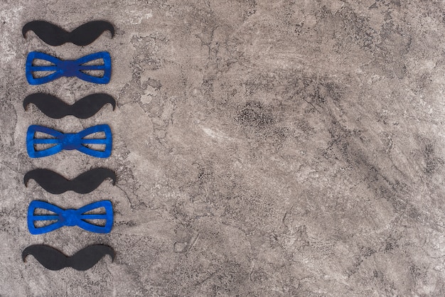 Free photo mustaches and bow ties in vertical row