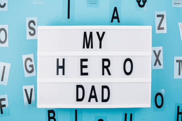 Free photo my hero dad title on tablet near letters