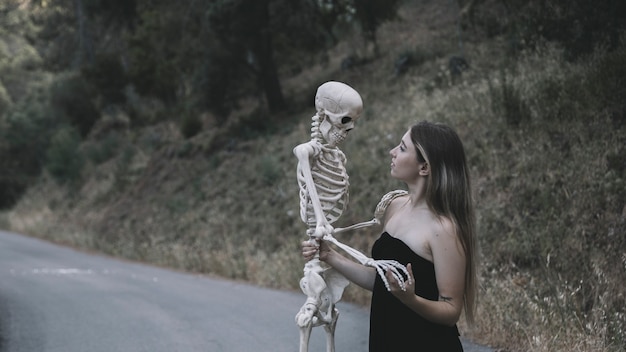 Mysterious lady holding skeleton 