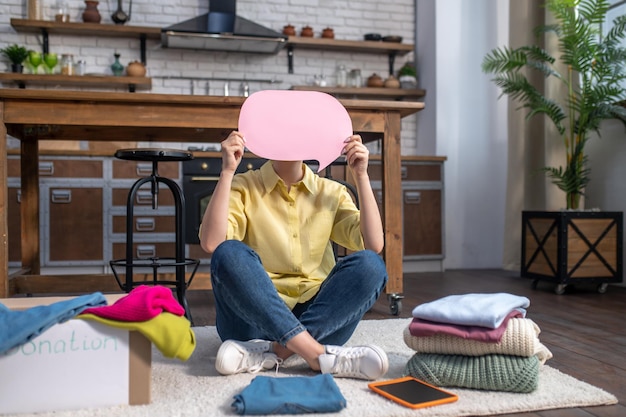 Free photo mysterious woman calling for donating unwanted clothes to charity