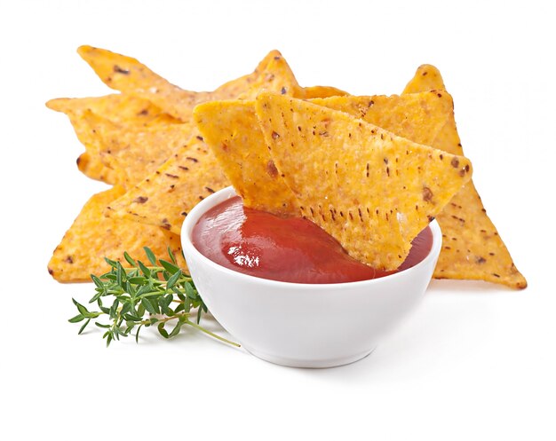 Nachos and tomato dip decorated with thyme leaves