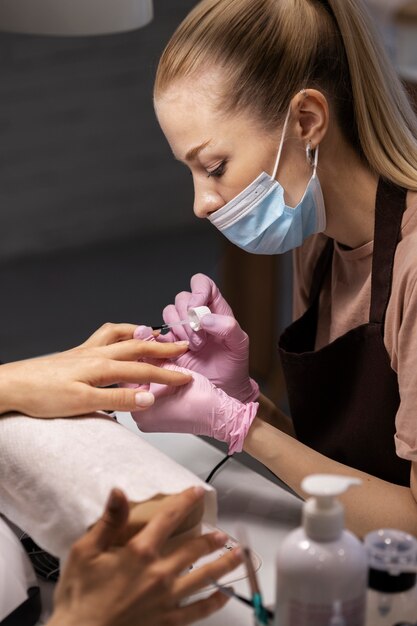 Nail art professional working on client nails