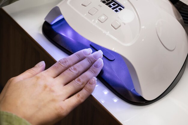 Nail art professional working on client nails