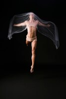 Голая гимнастка прыгает с прозрачной тканью
