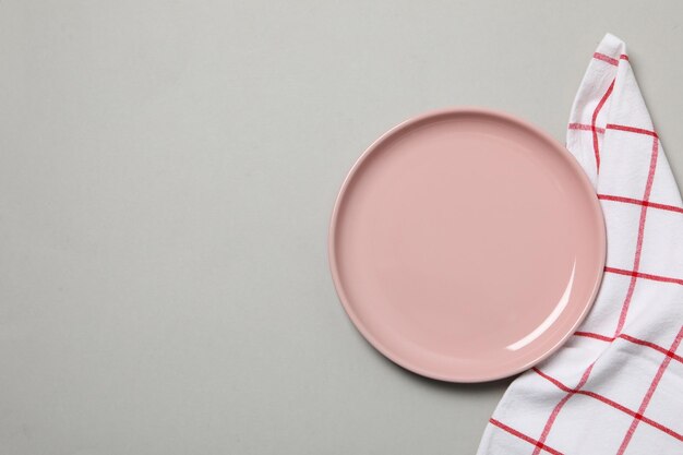 Napkin and plate on gray background space for text