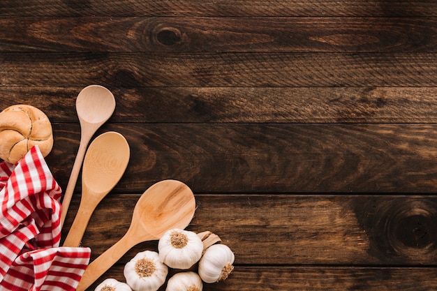 Napkin and spoons near bun and garlic