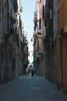 Free photo narrow alleyway in the middle of the buildings at venice italy