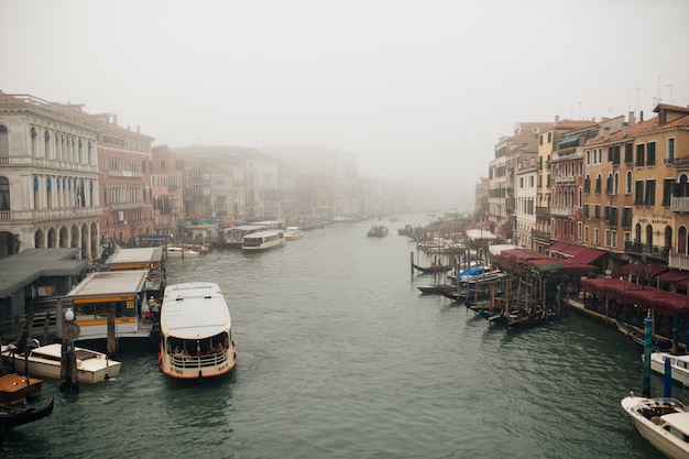 Narrow Canal among old colorful brick houses in Venice, Italy.