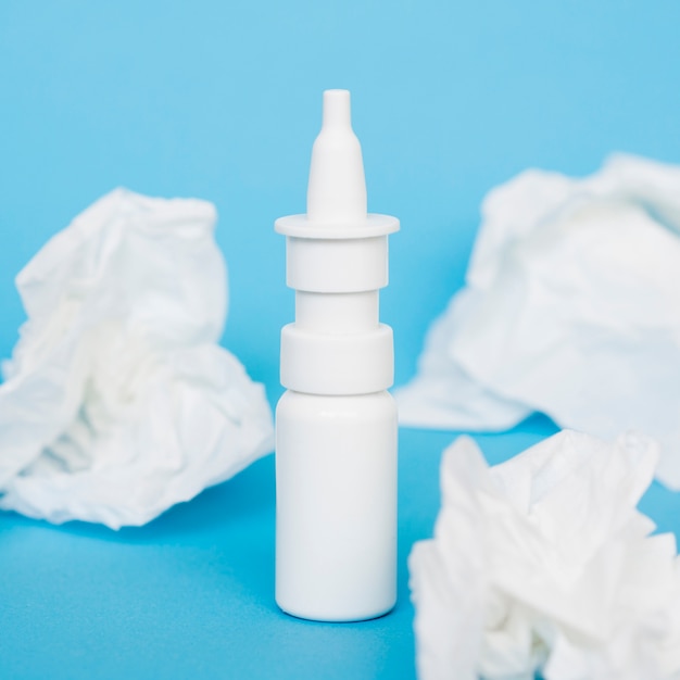 Nasal spray bottle and tissues