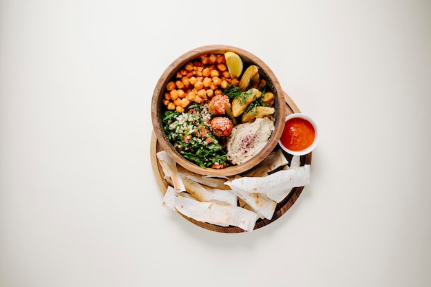 Free photo national piti with meat and herbs inside pottery bowl with lavash and ketchup.