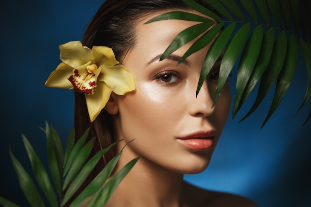 Natural beauty concepts. Beautiful woman with plants. 