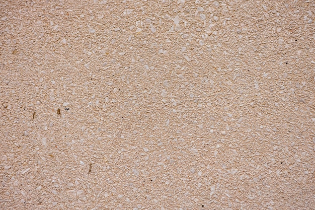 Natural beige stone wall texture and background