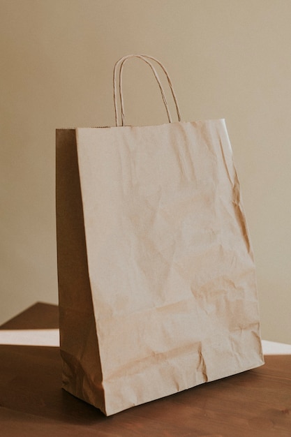 Free photo natural brown paper bag on wooden table