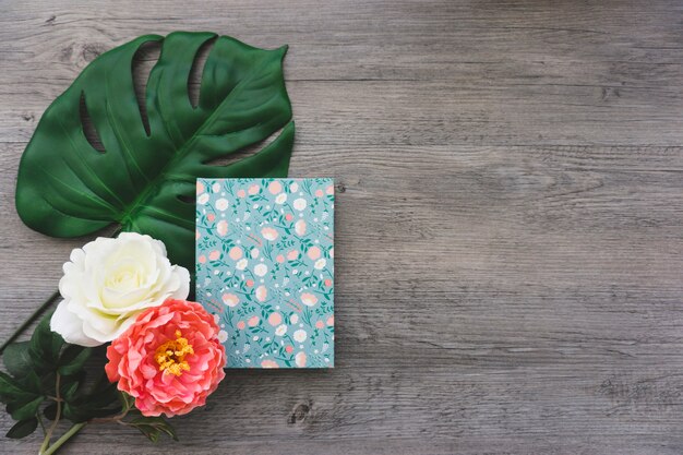 Natural composition with flowers and book