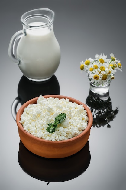 Natural dairy products, cottage cheese in a ceramic rustic cup. Close-up, selective focus, dark background . Farm curd, natural healthy food, diet food