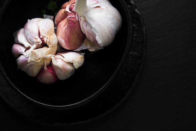 Natural garlic in bowl top view