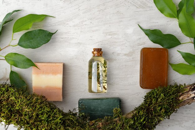 Natural handmade soap and plants on gray background
