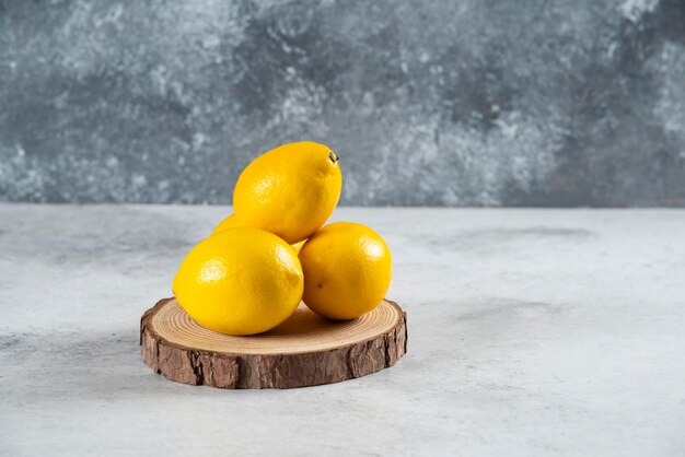 Natural lemon fruit isolated on white marble background.