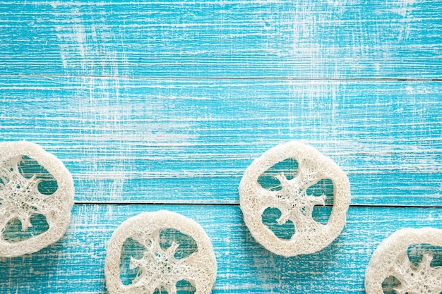 Free photo natural loofah on a blue wooden background top view