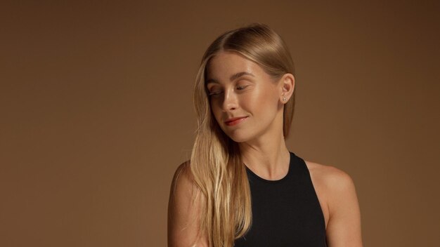 Natural looking model watching aside Blonde model in studio portrait