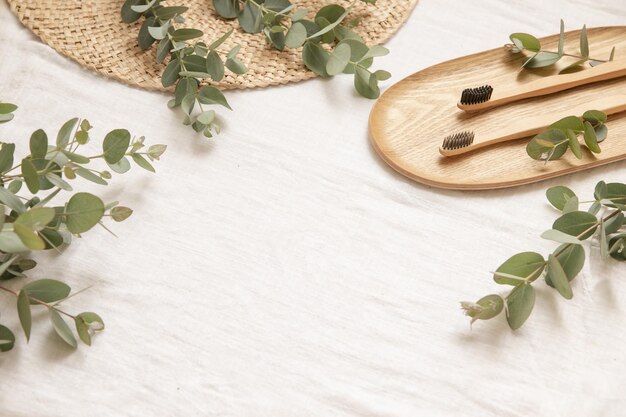 Natural materials style with leaves of eucalyptus on a light fabris background