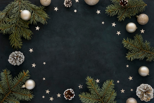 Natural pine needles and christmas globes on dark background