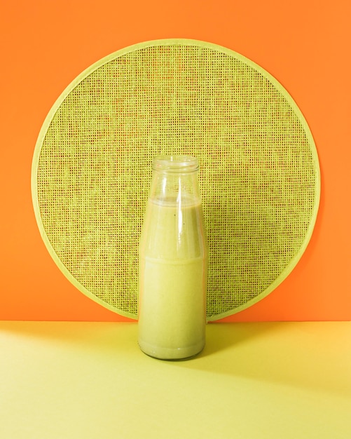 Natural smoothie in bottle on table