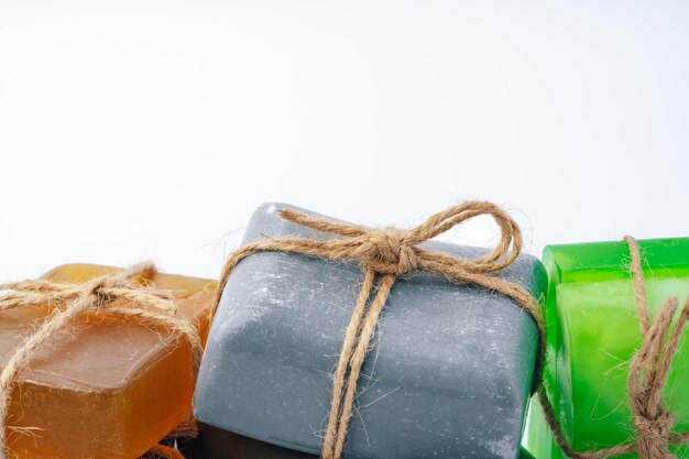 Natural soap bars tied with ribbon isolated on white