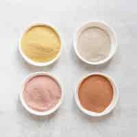 Free photo natural spa coloured sand in different bowls