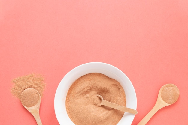 Natural spa sand in bowls and spoons filled with sand