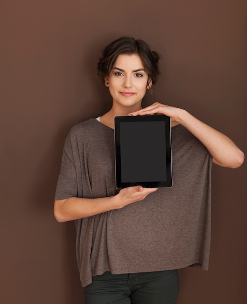 Natural woman showing screen of digital tablet