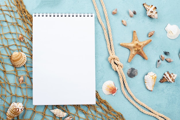 Free photo nautical rope beside notebook