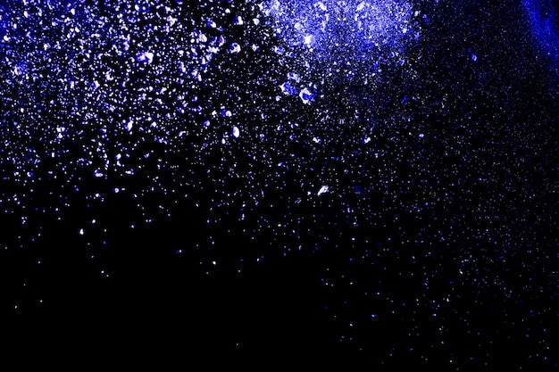 Premium Photo | Navy blue color powder explosion on black background.