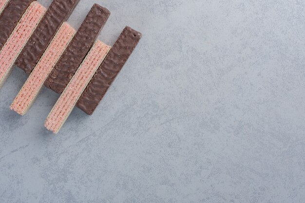 Neat row of delicious wafers on marble surface