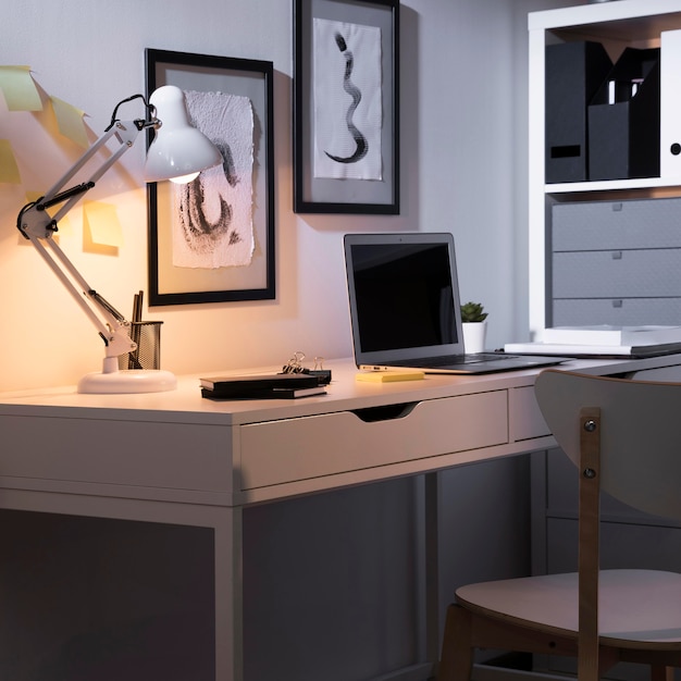 Neat and tidy workspace with laptop and lamp