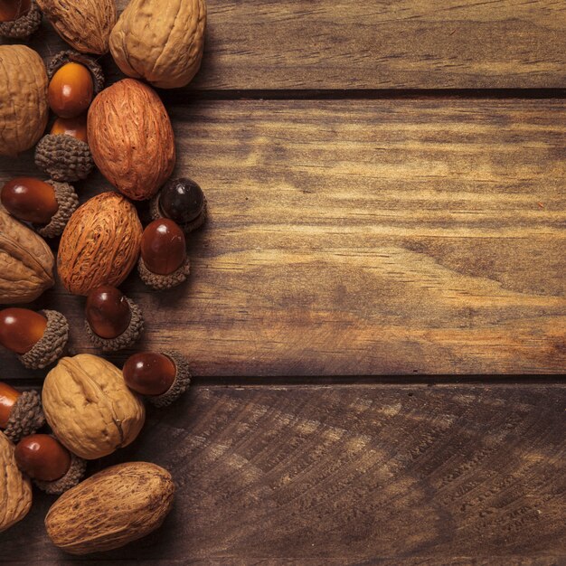 Neatly arranged autumn nuts on wooden table 