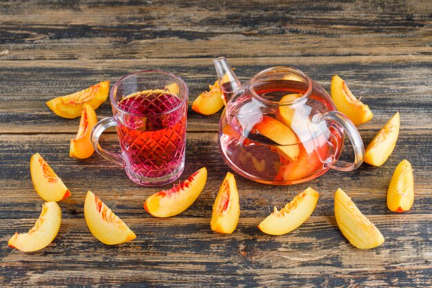 Nectarines with cold drink high angle view on a wooden table