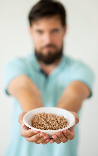 Needy man holding bowl of food