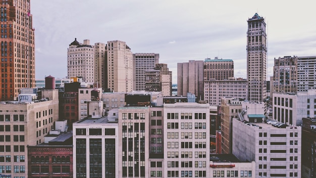 Free photo neighborhood with colorful modern buildings and skyscrapers under a cloudy sky