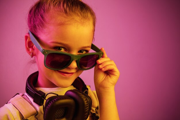Neon portrait of young girl with headphones enjoying music.