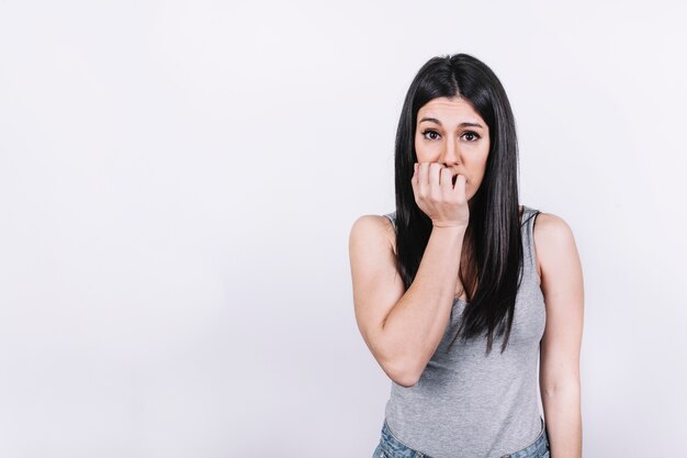 Nervous woman biting nails