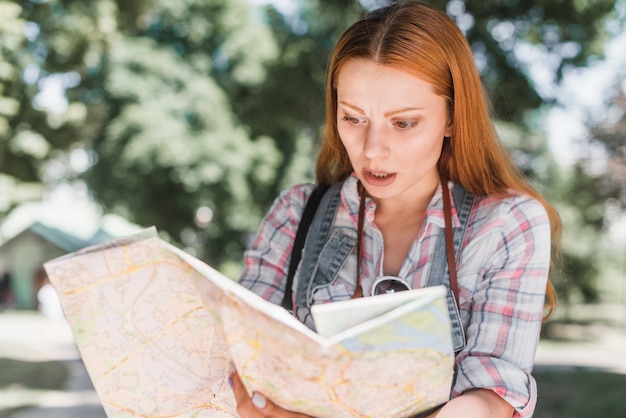 Free photo nervous woman with city map