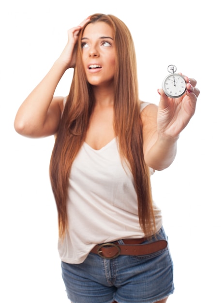 nervous woman with long hair holding stopwatch