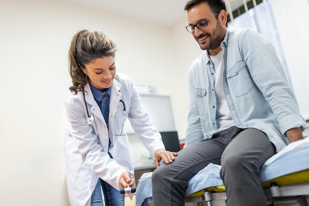 Free photo the neurologist testing knee reflex on a male patient using a hammer neurological physical examination selective focus close up