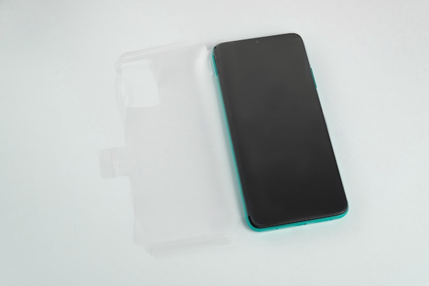 New cellphone with transparent cover over isolated white background