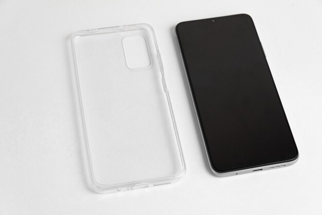 Новый мобильный телефон с прозрачной крышкой на изолированном белом фоне