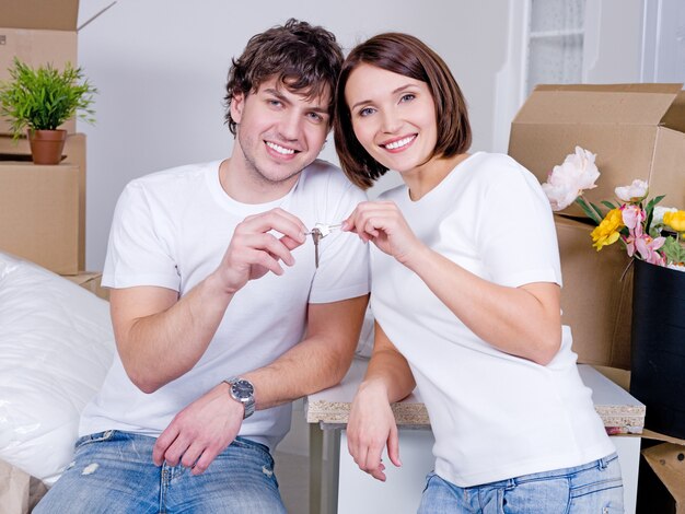 A new flat for young happy family -  holding keys